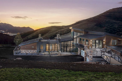 Contemporary brown two-story exterior home idea in Salt Lake City with a shed roof and a metal roof
