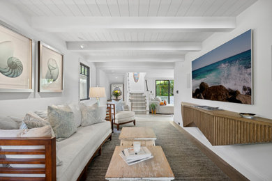 Family room - huge coastal open concept family room idea in Los Angeles with white walls