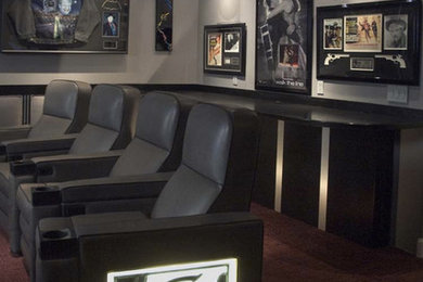 Large minimalist enclosed carpeted home theater photo in Las Vegas with gray walls and a projector screen