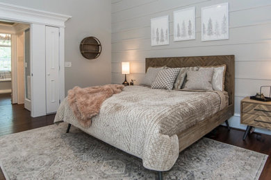 Bedroom - mid-sized rustic master medium tone wood floor, brown floor, vaulted ceiling and shiplap wall bedroom idea in Raleigh