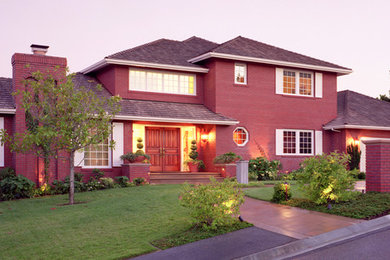 Inspiration for a large timeless red two-story brick exterior home remodel in San Francisco with a hip roof