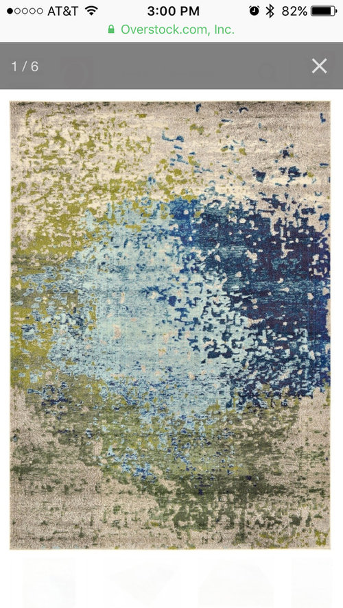 Coordinating curtains and area rug for family room