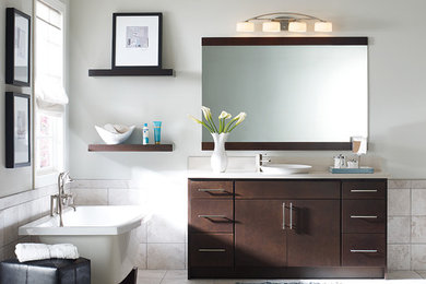 Design ideas for a mid-sized modern master bathroom in Other with flat-panel cabinets, brown cabinets, a freestanding tub, an open shower, a one-piece toilet, beige tile, porcelain tile, grey walls, slate floors, a vessel sink and granite benchtops.