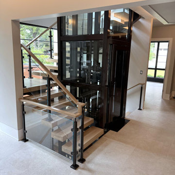 Project #136 | Modern Floating Staircase Encircling Glass Elevator