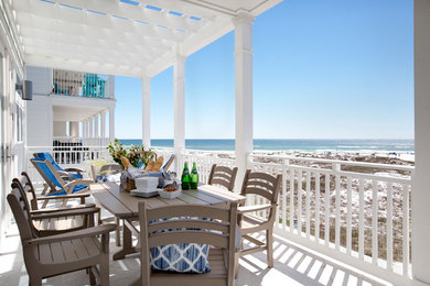 Photo of a beach style backyard verandah in Miami with a pergola.