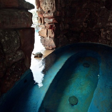 Lagoon style swimming pool with waterfall grotto with spa inside.