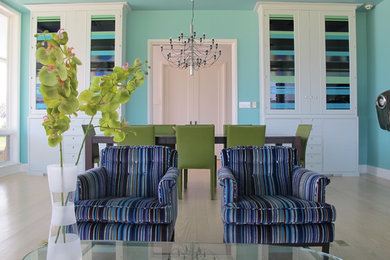 Example of a mid-sized eclectic light wood floor dining room design in New York with blue walls