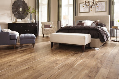 Example of a large eclectic master medium tone wood floor bedroom design in Salt Lake City with beige walls and no fireplace
