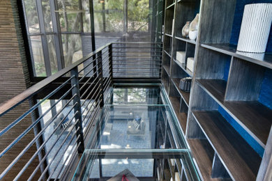 Home office library - large modern built-in desk home office library idea in Austin with blue walls