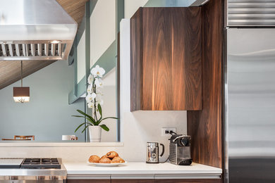 Large 1950s light wood floor and yellow floor eat-in kitchen photo in Chicago with an undermount sink, flat-panel cabinets, brown cabinets, quartzite countertops, stainless steel appliances, an island and white countertops