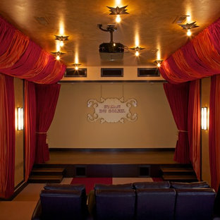 Home theater - beach style carpeted home theater idea in Grand Rapids with a projector screen