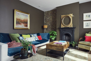 Eclectic living room in Dublin with brown walls and a standard fireplace.