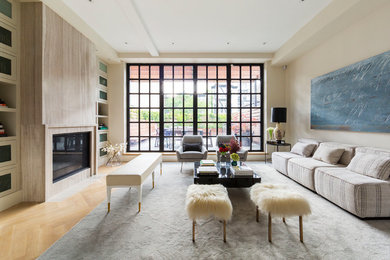 Inspiration for a large contemporary formal loft-style living room in New York with beige walls, light hardwood floors, a standard fireplace, a stone fireplace surround, no tv and beige floor.