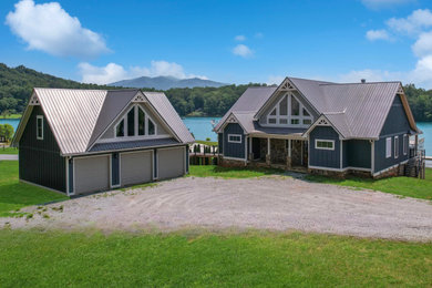 Arts and crafts two-story board and batten exterior home photo with a metal roof