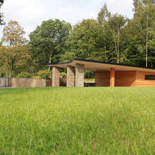 Outdoor spaces with natural stone walls, integrated fireplace and more.