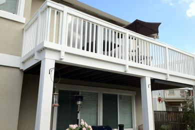 Inspiration for a mid-sized timeless backyard patio remodel in Sacramento with decking and an awning