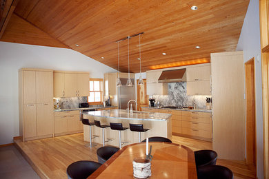 Inspiration for a mid-sized modern u-shaped light wood floor open concept kitchen remodel in Denver with flat-panel cabinets, light wood cabinets, gray backsplash, stainless steel appliances and an island