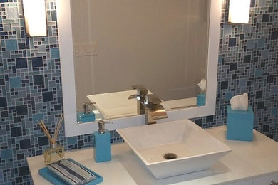 Powder room - mid-sized contemporary porcelain tile powder room idea in Other with flat-panel cabinets, white cabinets, a vessel sink and quartz countertops