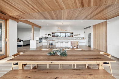 Inspiration for an expansive contemporary dining room in Geelong with white walls, light hardwood floors and wood.
