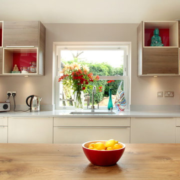 Open plan cashmere an wood kitchen with cube shelving