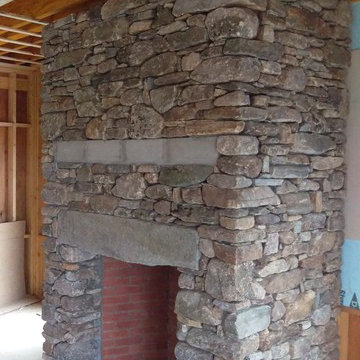 Full New England fieldstone veneer fireplace