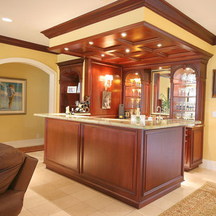 マイアミの大きいトラディショナルスタイルのおしゃれなウェットバー (レイズドパネル扉のキャビネット、中間色木目調キャビネット、御影石カウンター、黄色いキッチンパネル、セラミックタイルの床、ベージュの床、黄色いキッチンカウンター) の写真