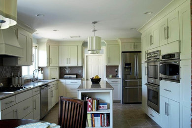 Inspiration for a mid-sized transitional open concept kitchen remodel in Chicago with shaker cabinets, white cabinets, quartzite countertops, stainless steel appliances and an island