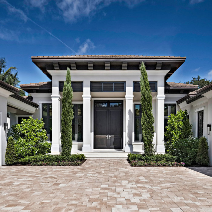 Mid-sized transitional one-story house exterior photo in Miami with a hip roof and a tile roof