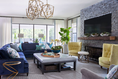 Inspiration for a large traditional open concept family room in Tampa with beige walls, ceramic floors, a standard fireplace, a built-in media wall and grey floor.
