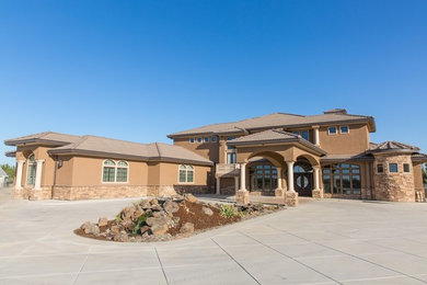 Huge traditional beige two-story mixed siding house exterior idea in Sacramento with a tile roof