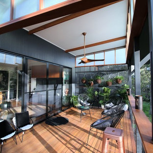 Photo of a small tropical home design in Brisbane.