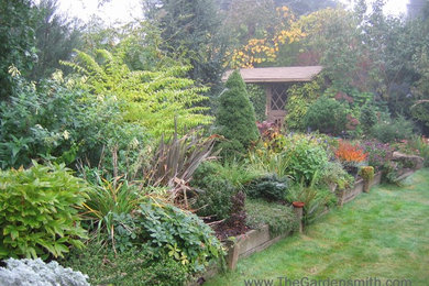 This is an example of a mid-sized eclectic backyard full sun garden in Portland.