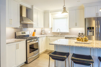 Eat-in kitchen - mid-sized transitional l-shaped porcelain tile and gray floor eat-in kitchen idea in Toronto with an undermount sink, shaker cabinets, white cabinets, granite countertops, subway tile backsplash, stainless steel appliances, an island and gray backsplash