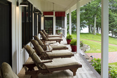 Farmhouse porch idea in Minneapolis with a roof extension
