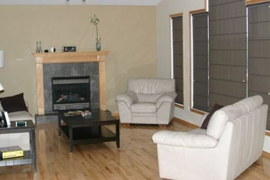 Living room - light wood floor living room idea in Other with beige walls, a standard fireplace and a tile fireplace