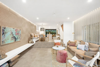 Photo of a contemporary living room with limestone floors and a wall-mounted tv.