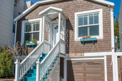 Inspiration for a large coastal brown two-story wood exterior home remodel in Boston with a clipped gable roof