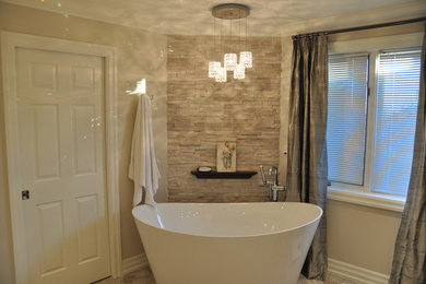 Bathroom - large traditional master beige tile and stone tile limestone floor bathroom idea in Toronto with recessed-panel cabinets, dark wood cabinets, a two-piece toilet, gray walls, an undermount sink and marble countertops