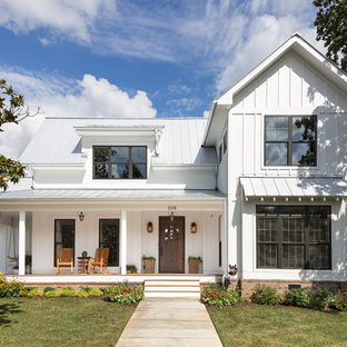 Example of a mid-sized farmhouse white two-story wood gable roof design in Nashville with a white roof