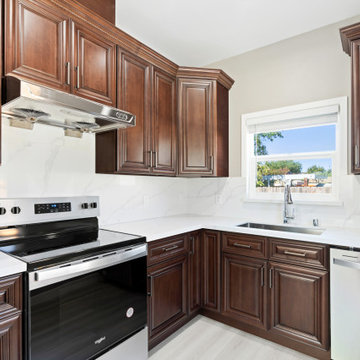 Traditional English Walnut Kitchen Remodel with Raised Panel Cabinets and Quartz
