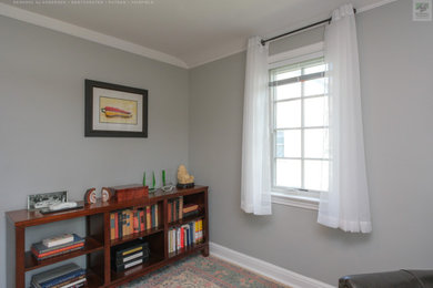 Inspiration for a mid-sized freestanding desk vaulted ceiling home office remodel in New York with gray walls