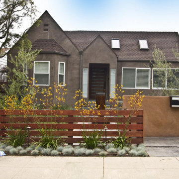 Craftsman Bungalow Front Exterior With Stucco Wall and Slat Fence