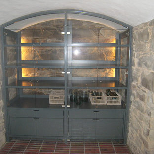 Medium sized farmhouse fully buried basement in Cologne with beige walls, brick flooring, no fireplace and red floors.