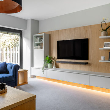 LUXURY FULLY FITTED LIVING ROOM WITH BESPOKE BOOKCASES AND MEDIA WALL