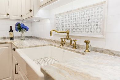 Inspiration for a mid-sized timeless galley light wood floor enclosed kitchen remodel in Atlanta with raised-panel cabinets, white cabinets, mosaic tile backsplash, white appliances and no island