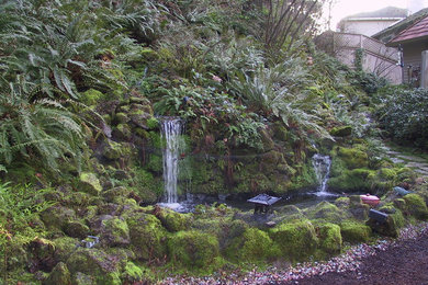 Photo of a mid-sized asian partial sun formal garden in Portland with a water feature.