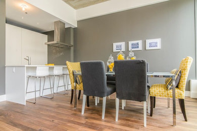 Inspiration for a mid-sized modern medium tone wood floor kitchen/dining room combo remodel in Montreal with gray walls and no fireplace