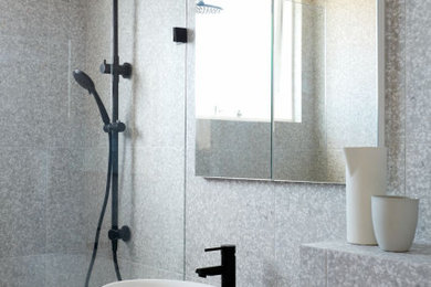 Small modern bathroom in Sydney with shaker cabinets, white cabinets, a shower/bathtub combo, a wall-mount toilet, gray tile, porcelain tile, grey walls, porcelain floors, engineered quartz benchtops, grey floor, an open shower, white benchtops, a single vanity and a floating vanity.