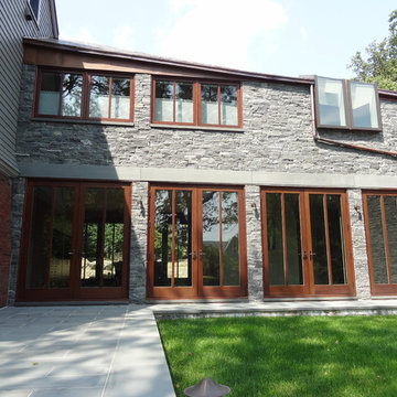 Traditional Newton Home with Greenwich Gray Stacked Stone Cladding