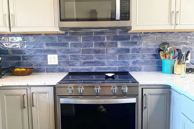 Inspiration for a small transitional kitchen remodel in Denver with blue backsplash